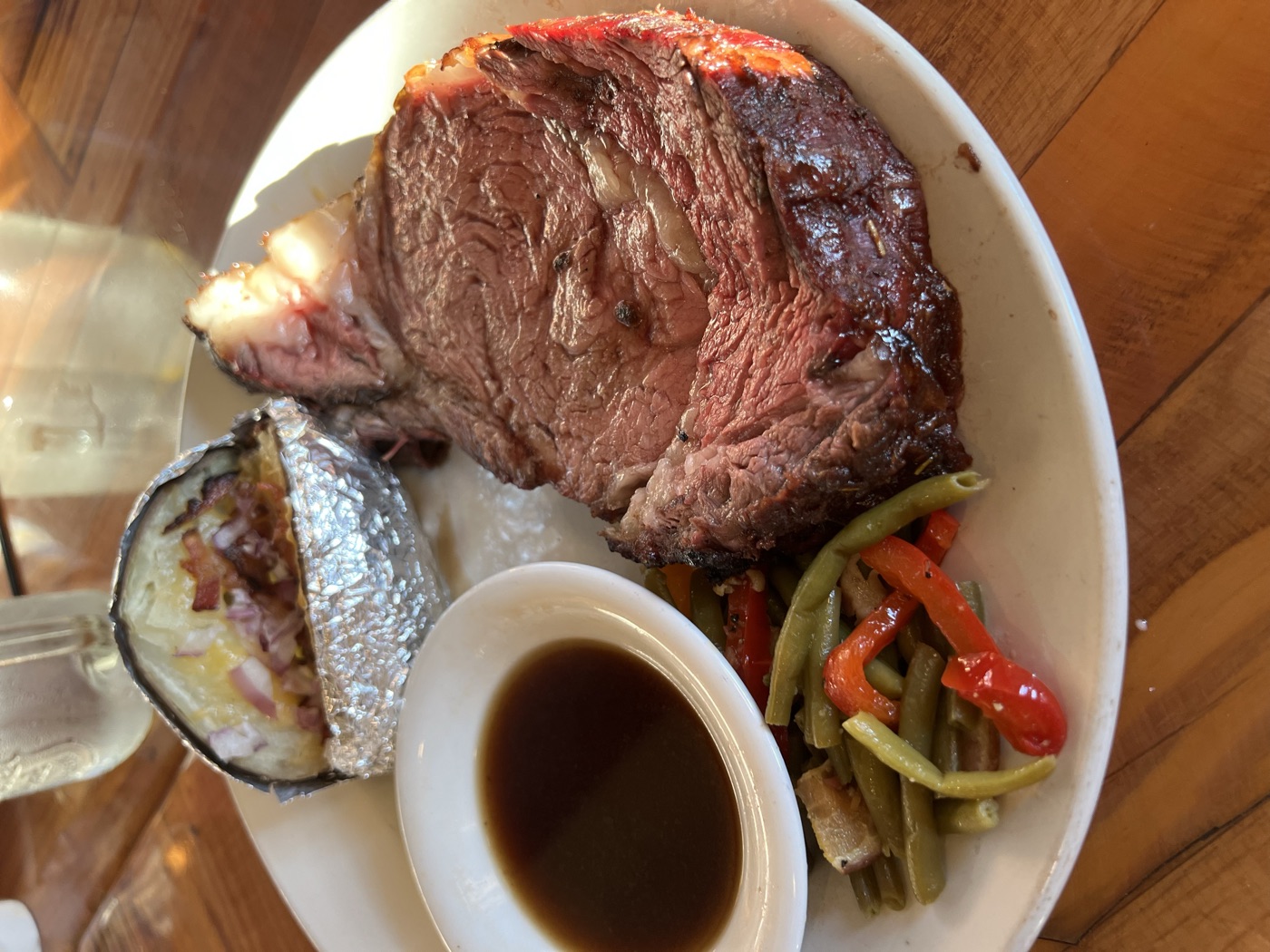 Au jus poured over a plate of smoked prime rib
