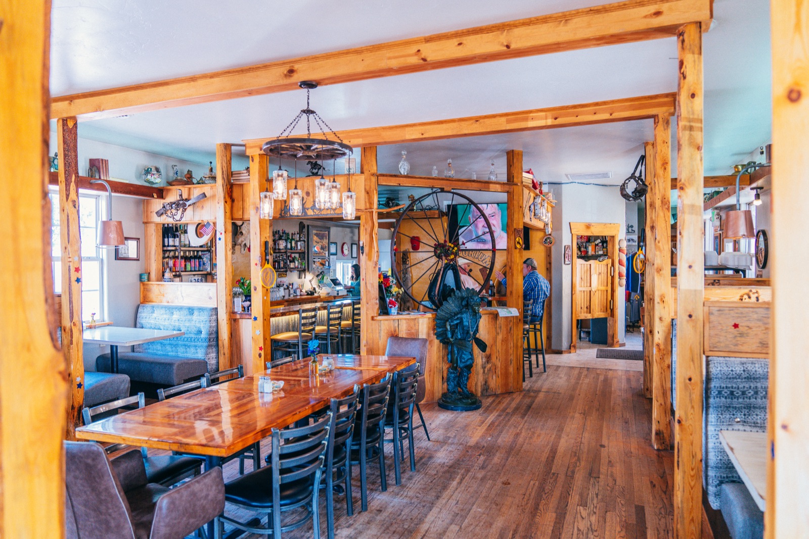 The long communal table and pendant lighting in the dining room