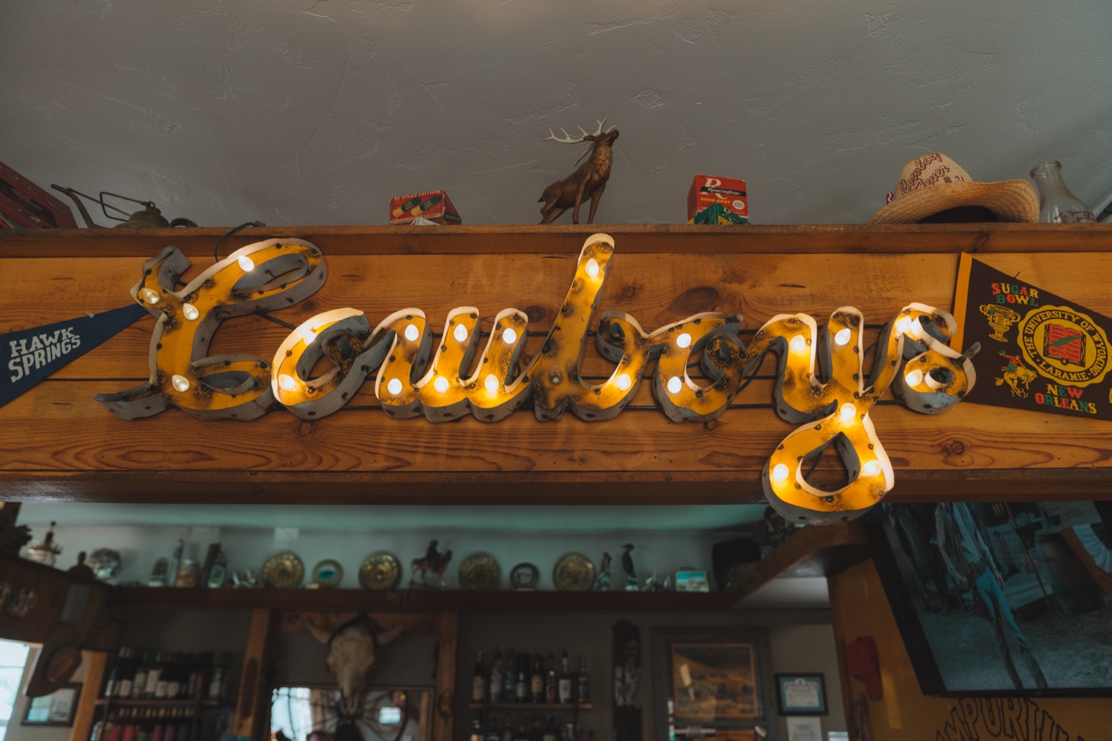 The illuminated Cowboys sign mounted on the beam above the party room