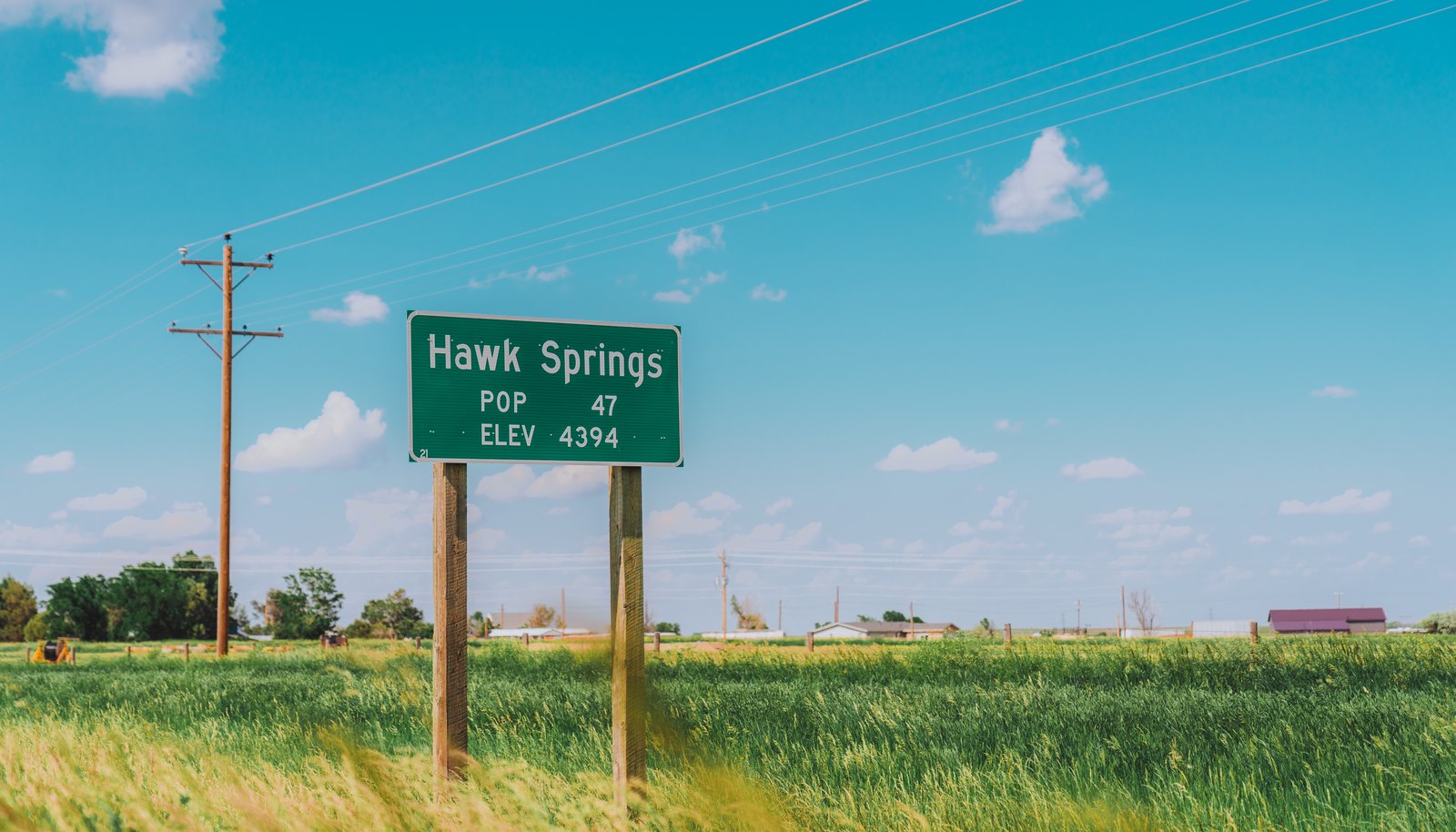 The Hawk Springs, Wyoming town sign on US Highway 85 — population 47, elevation 4,394 feet